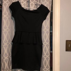 Black mini dress with a sewed in skirt look to it